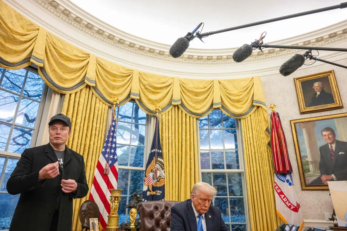 Elon Musk speaks as US President Donald Trump looks on in the Oval Office of the White House in Washington, DC, on February 11, 2025. Tech billionaire Elon Musk, who has been tapped by President Donald Trump to lead federal cost-cutting efforts, said the United States would go "bankrupt" without budget cuts. Musk leads the efforts under the newly created Department of Government Efficiency (DOGE), and was speaking at the White House with Trump, who has in recent weeks unleashed a flurry of orders aimed at slashing federal spending. (Photo by Jim WATSON / AFP)