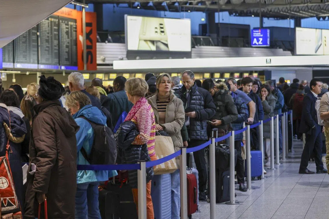 Passengers queue during a strike by airport security workers at Frankfurt's international airport.