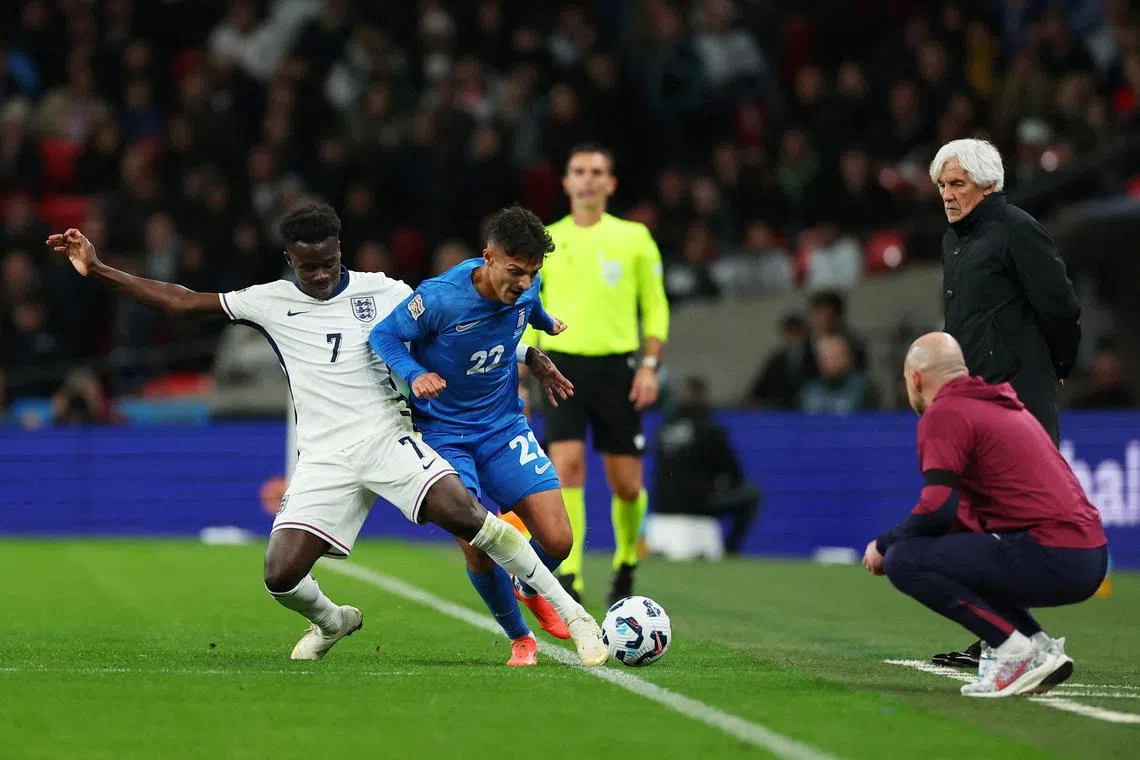 England's Bukayo Saka (left) in action with Greece's Dimitris Giannoulis during the Three Lions' shock 2-1 Nations League defeat at Wembley on Oct 10, as Greece coach Ivan Jovanovic and England interim manager Lee Carsley look on 