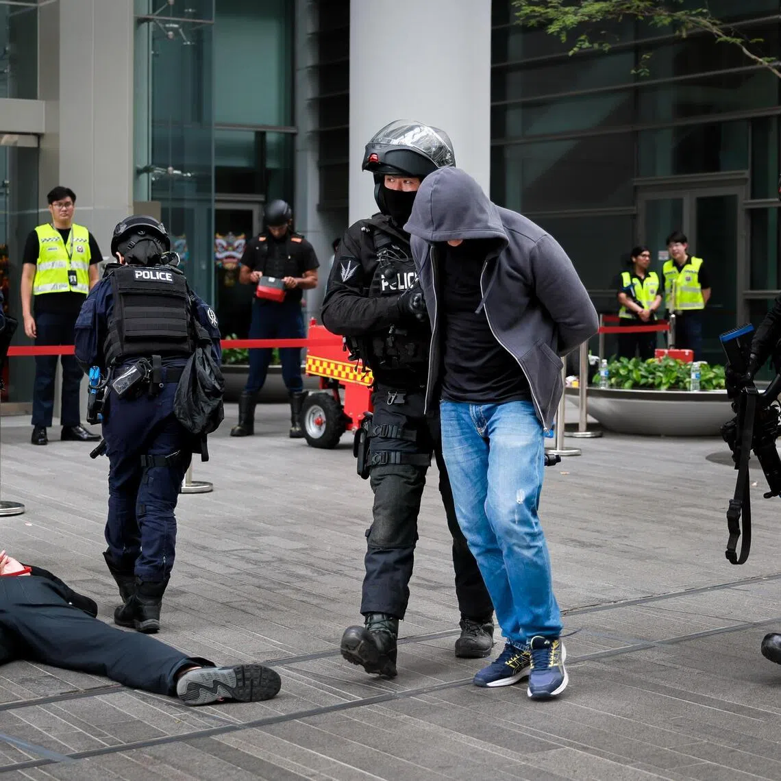 The Police Tactical Unit apprehend terrorists in a simulated attack at the counter-terrorism exercise Heartbeat at NUS Utown  on Feb 13, 2026.
