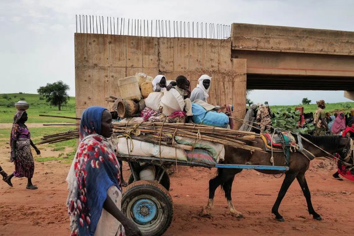 FILE PHOTO: A Chadian cart owner transports belongings of Sudanese people who fled the conflict in Sudan's Darfur region, while crossing the border between Sudan and Chad in Adre, Chad August 4, 2023. REUTERS/Zohra Bensemra/File Photo