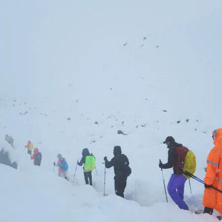 A screengrab from video shows trekkers leaving their campsite, as unusually heavy snow and rainfall pummeled the Himalayas, in the Tibet Region, China, Oct 5.