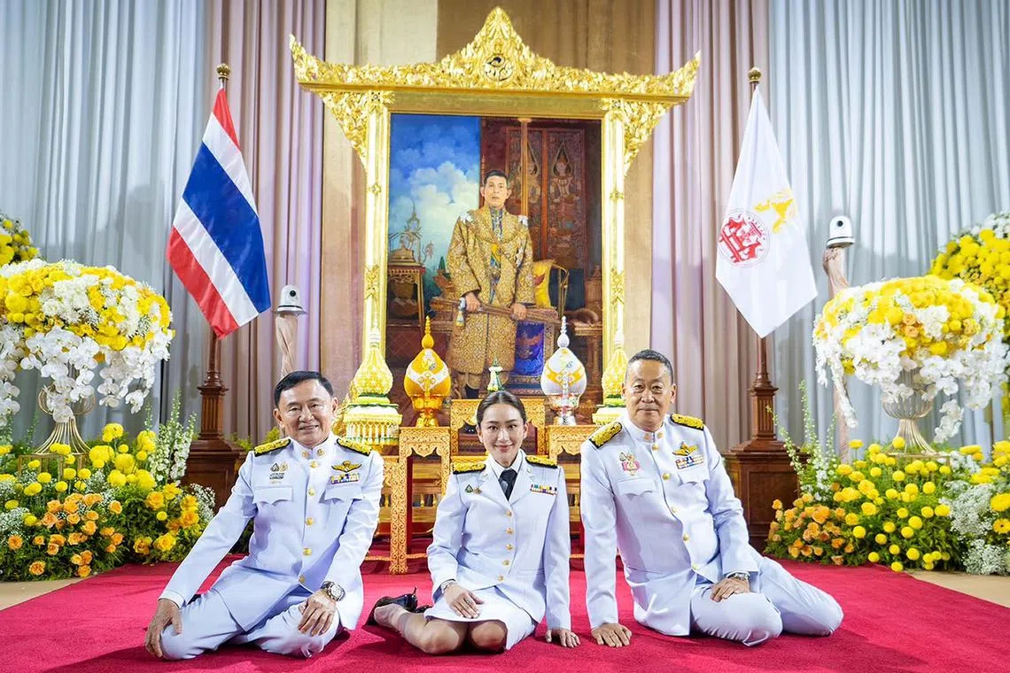 epa11553879 A handout photo made available by the Pheu Thai Party shows Thailand's newly elected Prime Minister Paetongtarn Shinawatra (C) next to her father, former premier Thaksin Shinawatra (L) and former prime minister Srettha Thavisin (R) while posing for a photo after she received a royal command appointment to become prime minister, in front of a portrait of the King at Pheu Thai Party's headquarters in Bangkok, Thailand, 18 August 2024. The ruling Pheu Thai Party leader Paetongtarn Shinawatra, the youngest daughter of the coup-ousted former premier Thaksin Shinawatra, succeeded in the parliamentary vote to become Thailand's 31st prime minister and the country's youngest prime minister in history. EPA-EFE/THE PHEU THAI PARTY / HANDOUT HANDOUT HANDOUT EDITORIAL USE ONLY/NO SALES