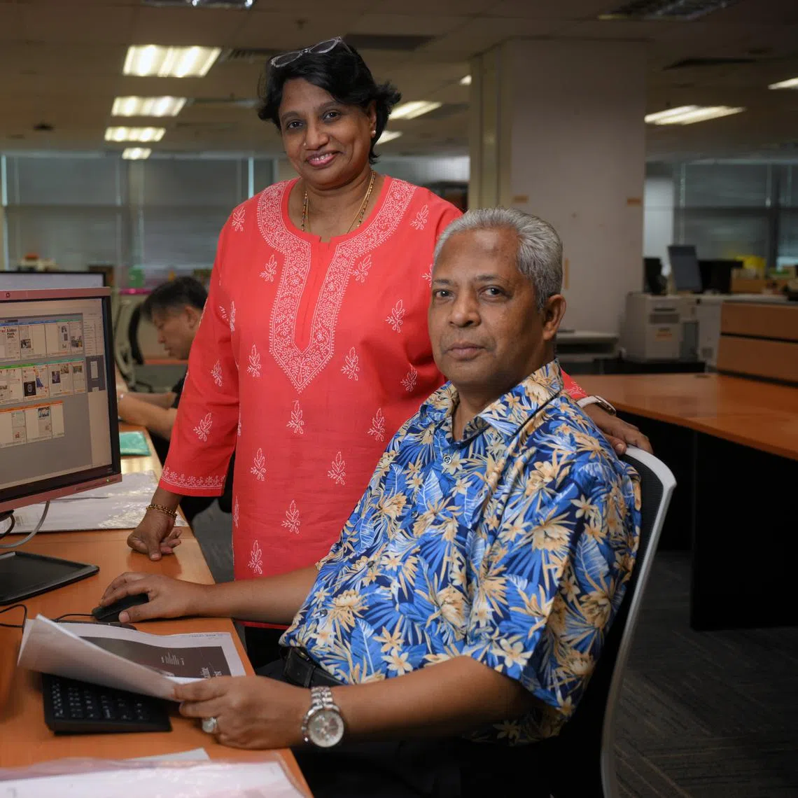 Production manager Sumithy Kamalakaran (standing) and senior pre-press specialist Abdul Razak of the pre-press team.