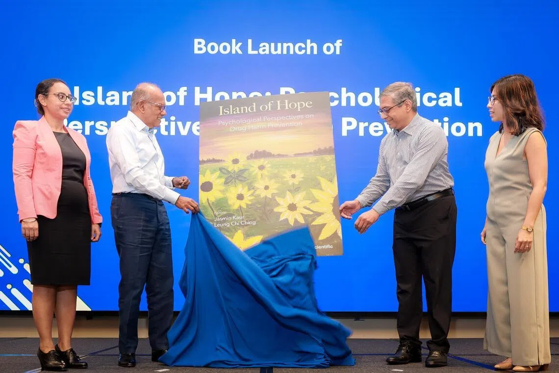 Home Affairs Minister K. Shanmugam, with (from left) MHA senior principal psychologist Jasmin Kaur; MHA chief psychologist Majeed Khader; and MHA lead psychologist Leung Chi Ching on March 12.