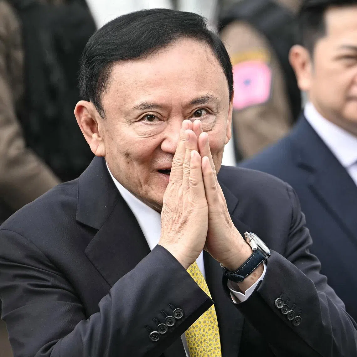 (FILES) Thailand's former Prime Minister Thaksin Shinawatra arrives at the Supreme Court in Bangkok on September 9, 2025, ahead of a ruling on whether he properly served a prison term in 2023. Thailand's influential former prime minister Thaksin Shinawatra has applied for a royal pardon to reduce his one-year prison sentence, his lawyer told reporters on September 29, 2025. (Photo by Lillian SUWANRUMPHA / AFP)