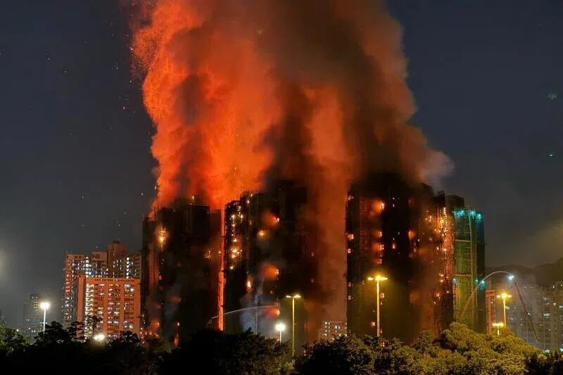 Thick smoke and flames rise as a major fire engulfs several apartment blocks at the Wang Fuk Court residential estate in Hong Kong on Nov 26. 