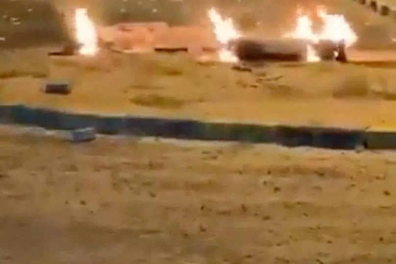 Debris burns on the ground in a parking lot following reports of missile and drone attacks, in Sabah Al Nasser, Kuwait June 3, 2026, in this screengrab obtained from a social media video . SOCIAL MEDIA/via REUTERS
