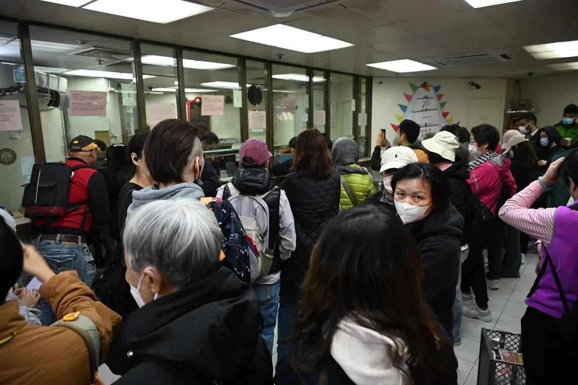 People queue inside a gold dealer in Hong Kong to buy up bars of silver.
