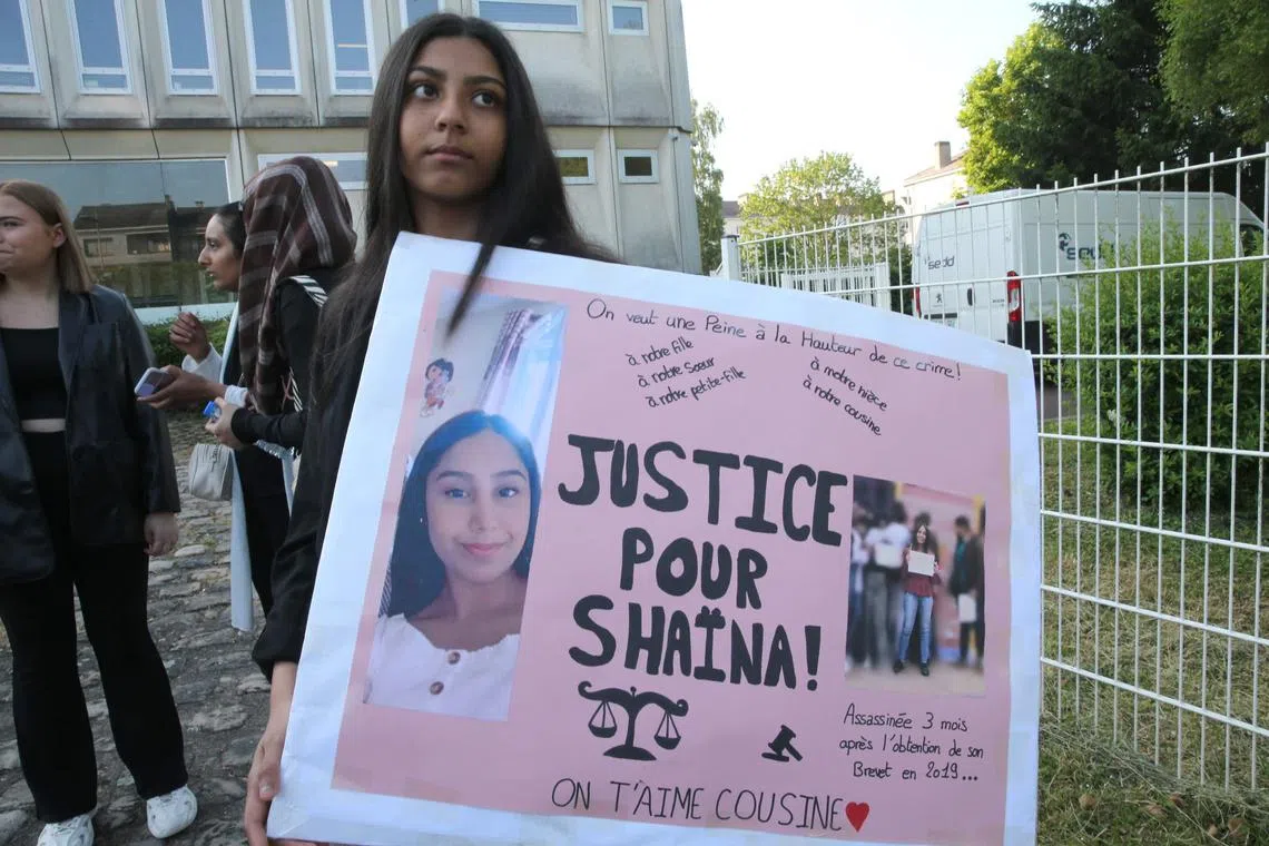 A relative holds a placard reading "Justice for Shaina" prior to the trial of the alleged murderer of Shaina Hansye, accused of murdering and burning alive the 15-year-old girl in 2019, at the Juvenile Assize Court of Beauvais, northern France, on June 5, 2023. (Photo by François NASCIMBENI / AFP)