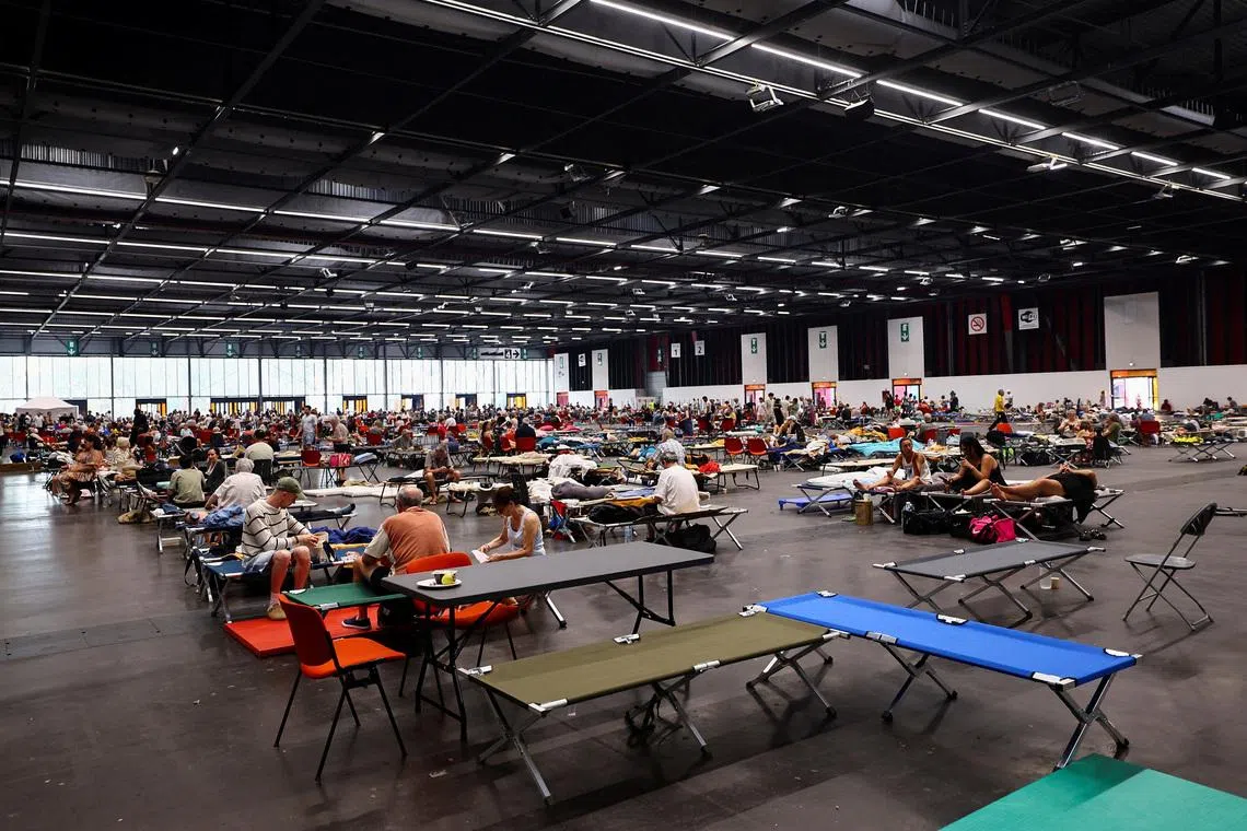 FILE PHOTO: Evacuated residents rest at the Bordeaux-Lac Exhibition Centre, which has been turned into a shelter for people displaced by a wildfire burning nearby amid worsening drought conditions following a heatwave and water shortages across much of France, in Bordeaux, France, July 25, 2026. REUTERS/Manon Cruz/File Photo