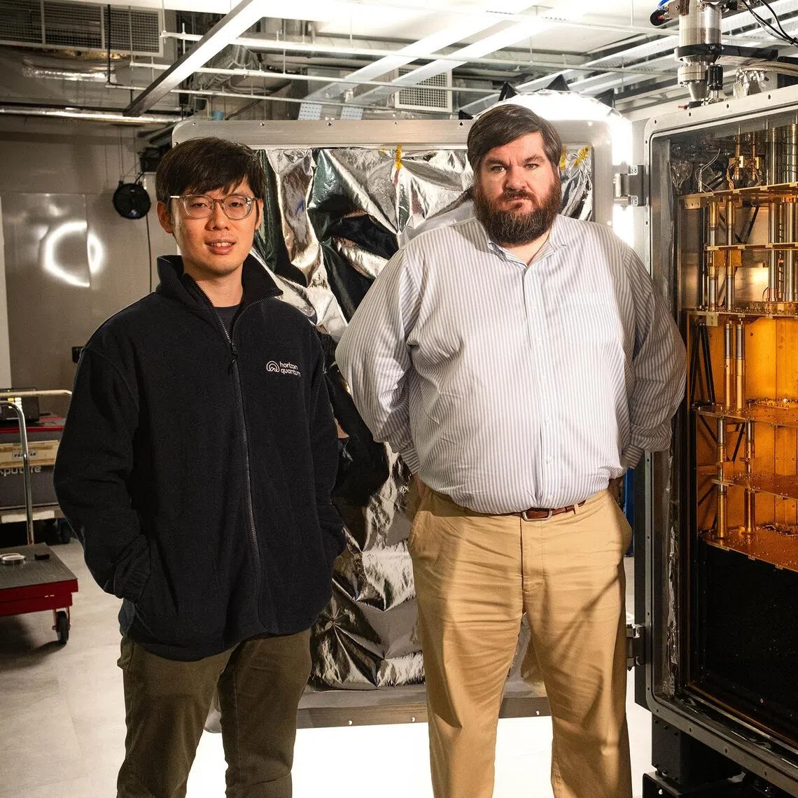 Singapore-trained staff engineer Kyle Chu and chief executive and founder of Quantum Horizon, Dr Joe Fitzsimons, showing the quantum computer they have assembled for US$2.3 million at their Mediapolis office on Dec 3.