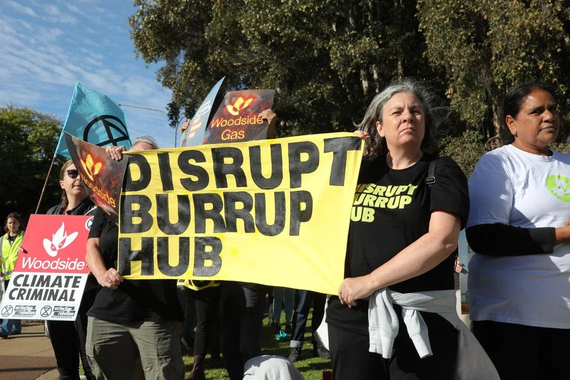 Protesters near Crown Towers, the venue for the Woodside Energy Group Ltd. annual general meeting in Perth, Australia, on Wednesday, April 24, 2024. Major investors are opposing Woodside's climate plans and the chairman’s reelection, raising questions about the strategy of Australia’s largest energy company as it rushes to expand oil and natural gas output. Photographer: Philip Gostelow/Bloomberg