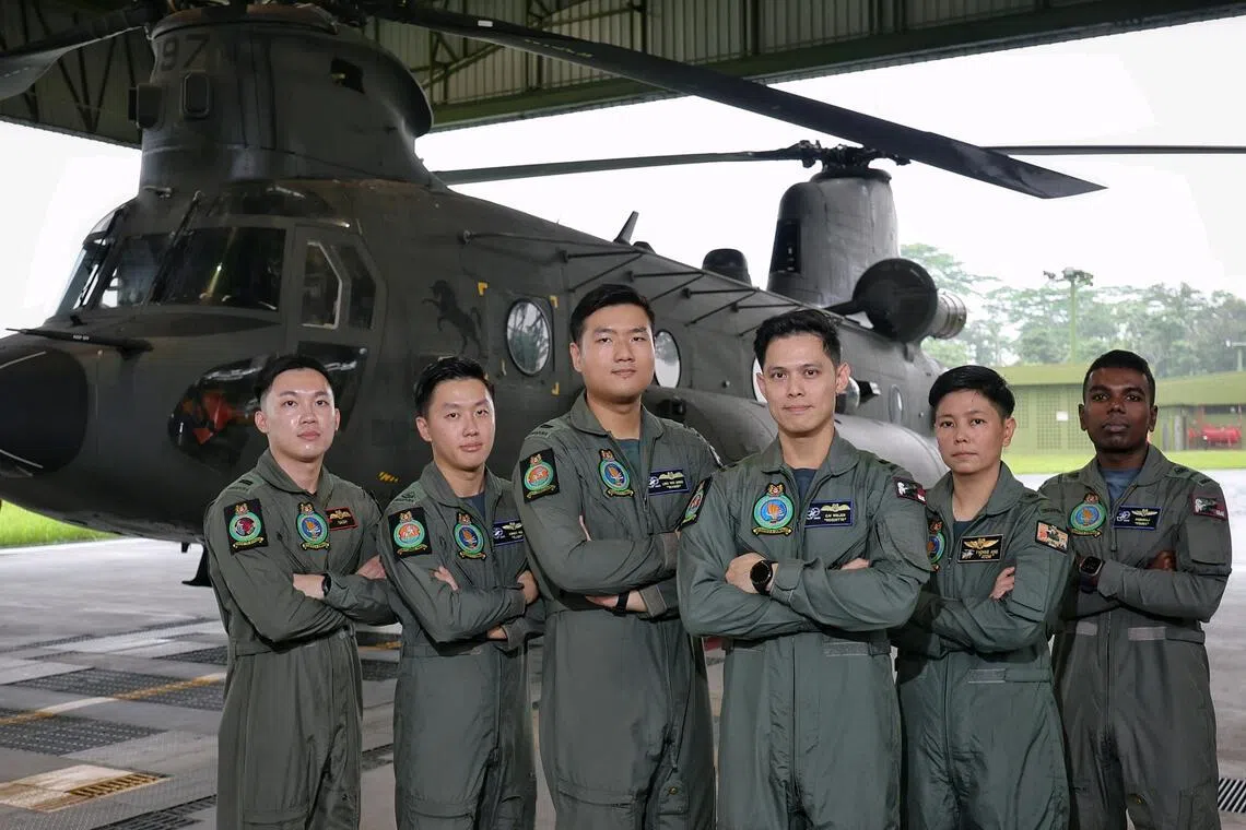 The aircrew of the NDP 2026 state flag flypast, led by Lieutenant-Colonel Cai Weijun (third from right), in front of the CH-47 Chinook helicopter.