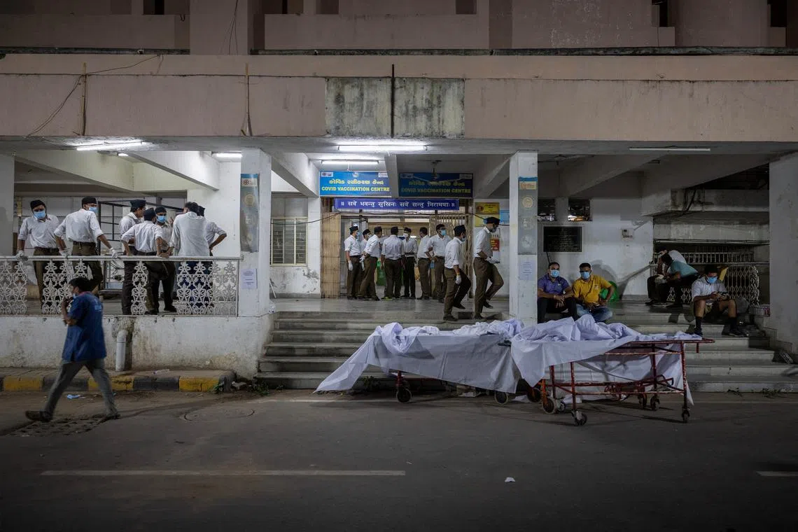 Volunteers standing next to stretchers for the victims who died when an Air India Boeing 787-8 Dreamliner plane bound for London's Gatwick Airport, crashed during take-off from Ahmedabad, at a hospital in Ahmedabad, India, on June 12, 2025. 