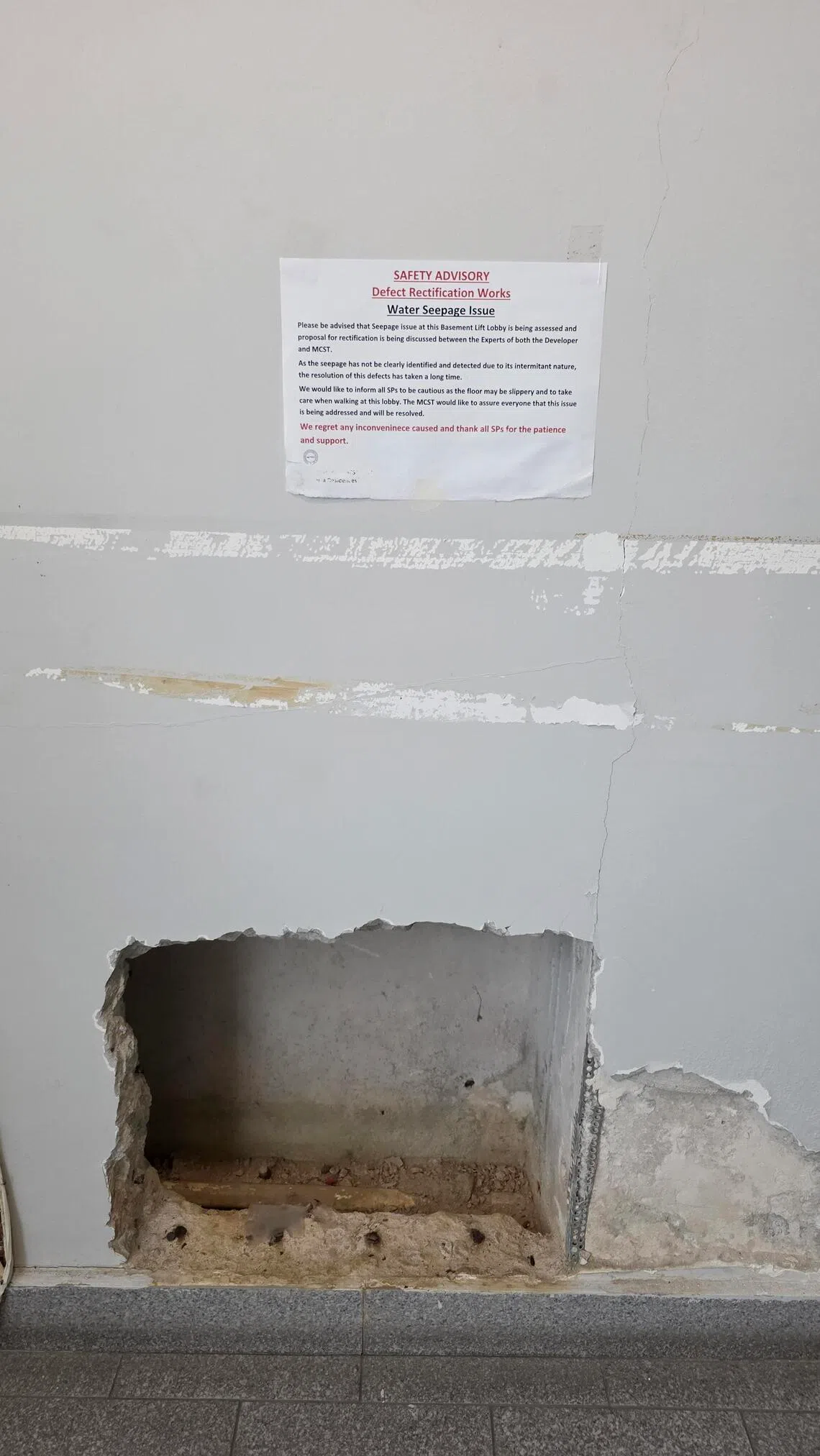 A notice put up at one of the lift lobbies at the basement carpark to caution residents of the slipper floor due to the water seepage issue.