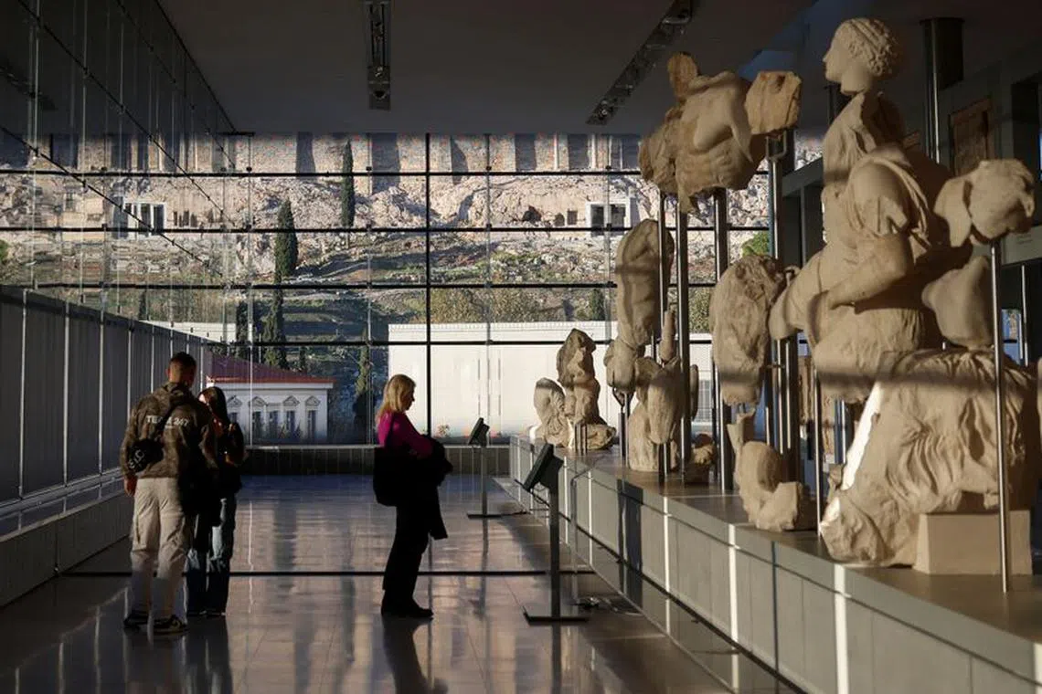 People visit the Parthenon Gallery, designed to accommodate the sculptures of the Parthenon, at the Acropolis Museum in Athens, Greece, November 27, 2023. REUTERS/Louisa Gouliamaki