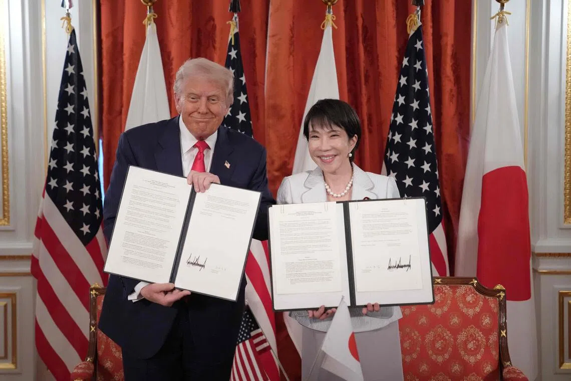 US President Donald Trump (left) and Japanese Prime Minister Sanae Takaichi (right) hold up signed documents for a critical minerals/rare earth deal during a meeting at Akasaka Palace on Oct 28, 2025 in Tokyo, Japan.  