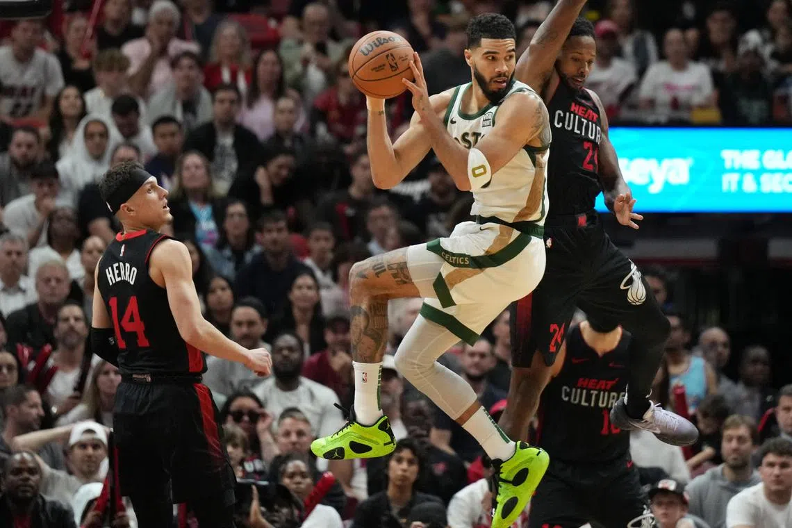 Boston Celtics forward Jayson Tatum looking to pass the ball as Miami Heat guard Terry Rozier defends on the play during the second half at Kaseya Center on Feb 11. Boston won 110-106.