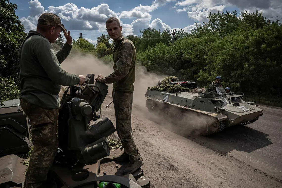 Ukrainian servicemen riding an armoured personnel carrier near the border with Russia, in Ukraine's Sumy region.
