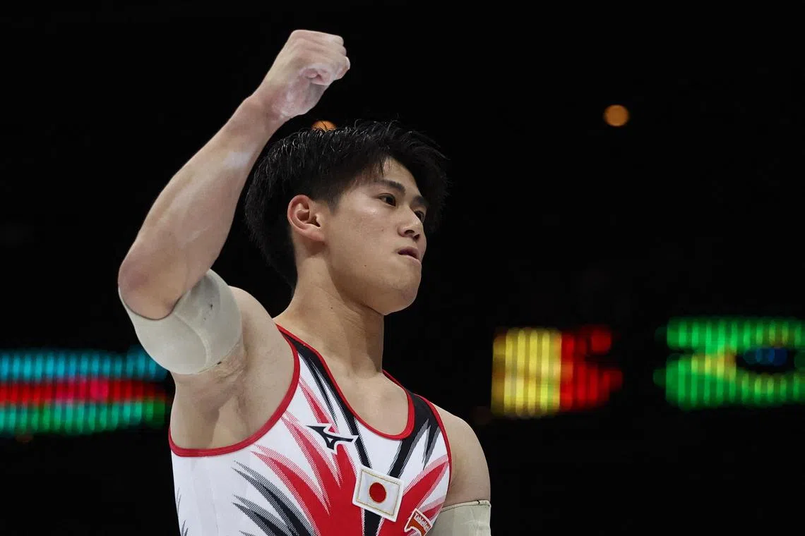 Japan's Daiki Hashimoto reacting after his routine on the parallel bars during the men's team final.