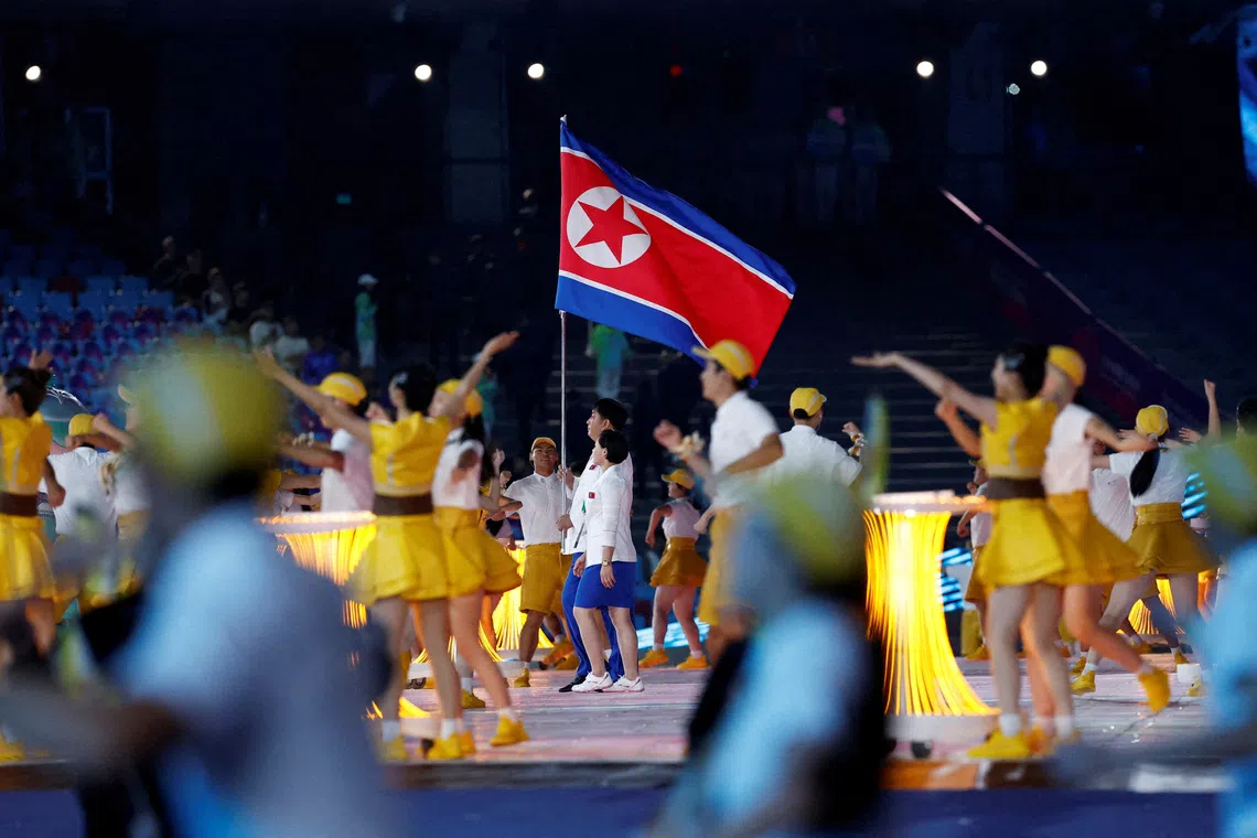 FILE PHOTO: Asian Games - Hangzhou 2022 - Opening Ceremony - Hangzhou Olympic Sports Center Stadium, Hangzhou, China - September 23, 2023 Athletes from North Korea hold their national flag at the Opening Ceremony REUTERS/Tingshu Wang./File Photo
