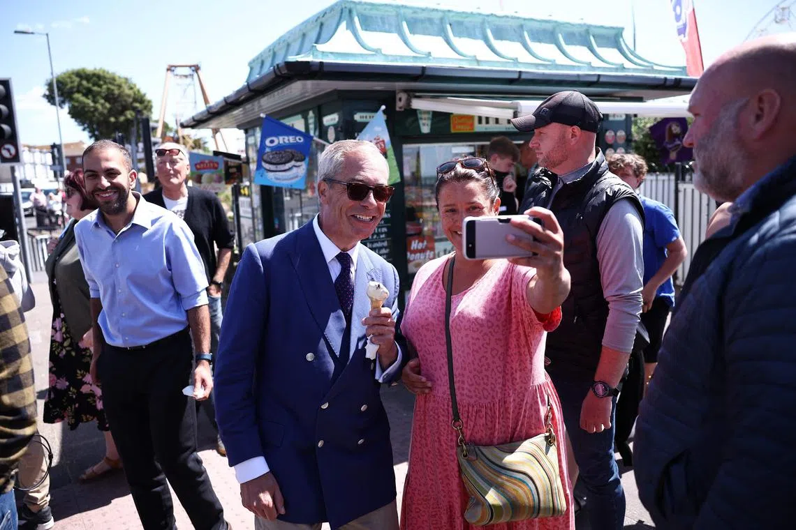 Reform UK leader Nigel Farage poses for a selfie with a resident on July 4.