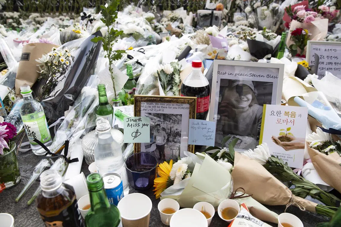 Flowers and pictures are laid as tribute to victims of the Seoul Halloween stampede, in Seoul, South Korea, Nov 1, 2022. 