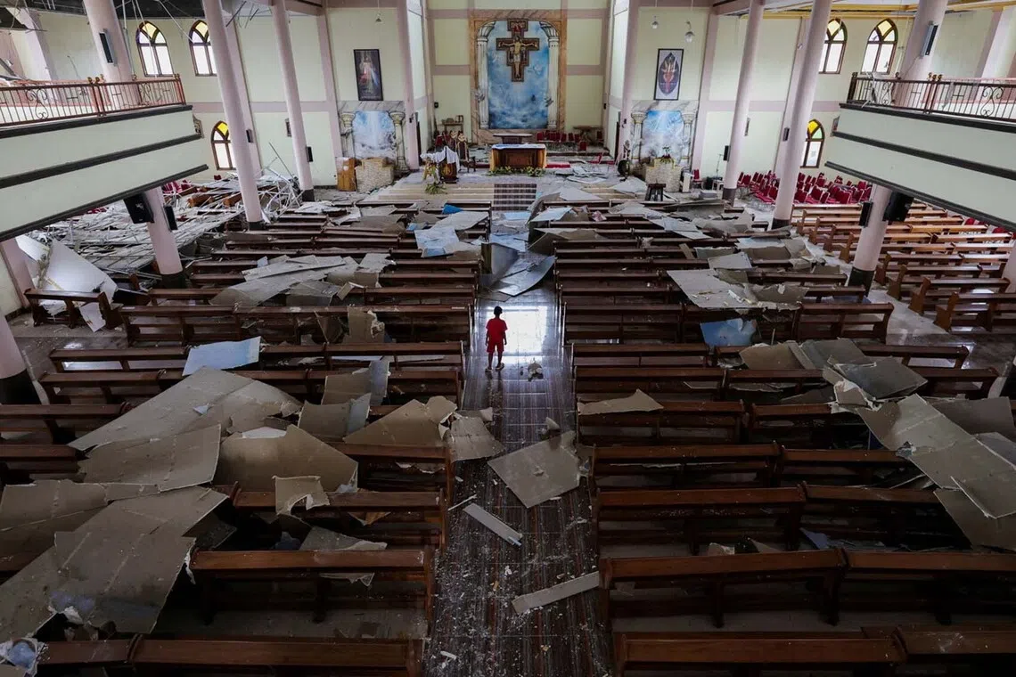 A child observes the damage at the St. Fransiskus Asisi-Karot church, in the aftermath of an earthquake, in Ruteng, Manggarai regency, East Nusa Tenggara province, Indonesia, August 17, 2026. REUTERS/Willy Kurniawan TPX IMAGES OF THE DAY