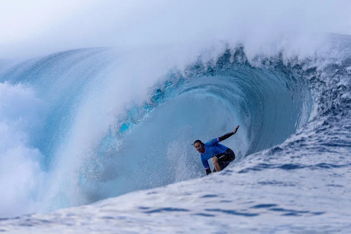 FILE PHOTO: Paris 2024 Olympics - Surfing - Men's Round 3 - Heat 1 - Teahupo'o, Tahiti, French Polynesia - July 29, 2024. Jordy Smith of South Africa rides a wave. Ed Sloane/Pool via REUTERS/File Photo