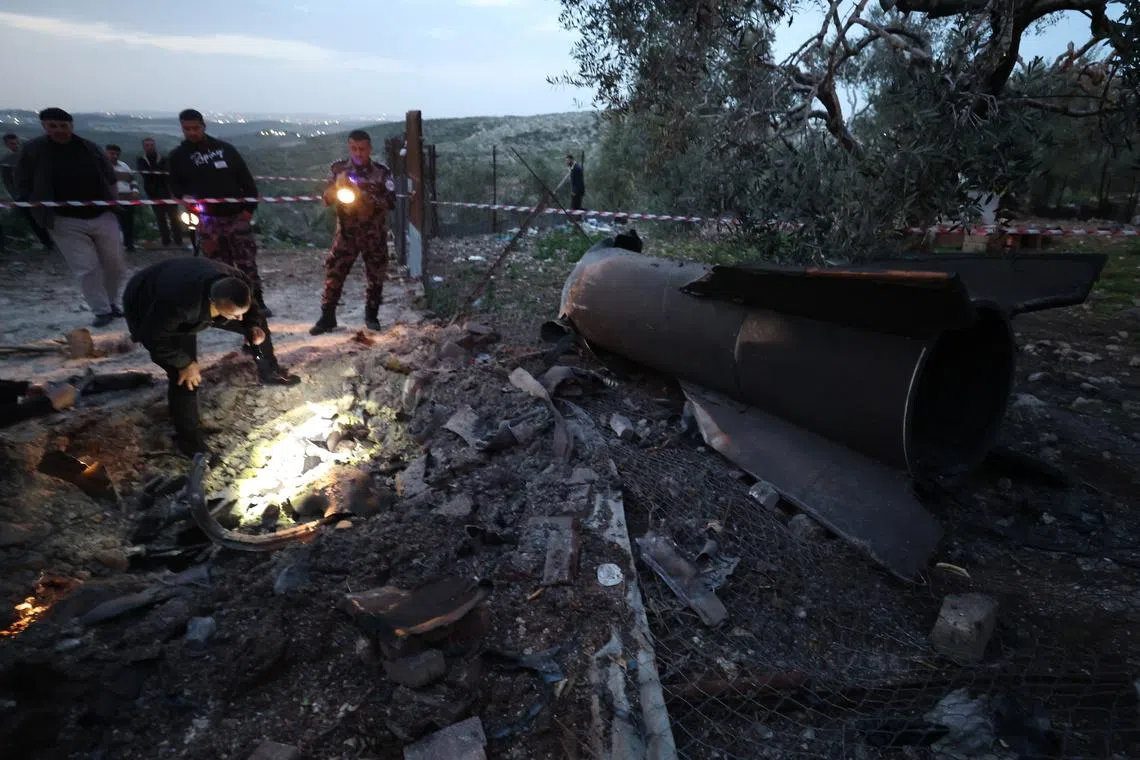 Palestinian officials inspecting the remains of a ballistic missile that landed in Anza village, near the West Bank city of Jenin, on March 20.