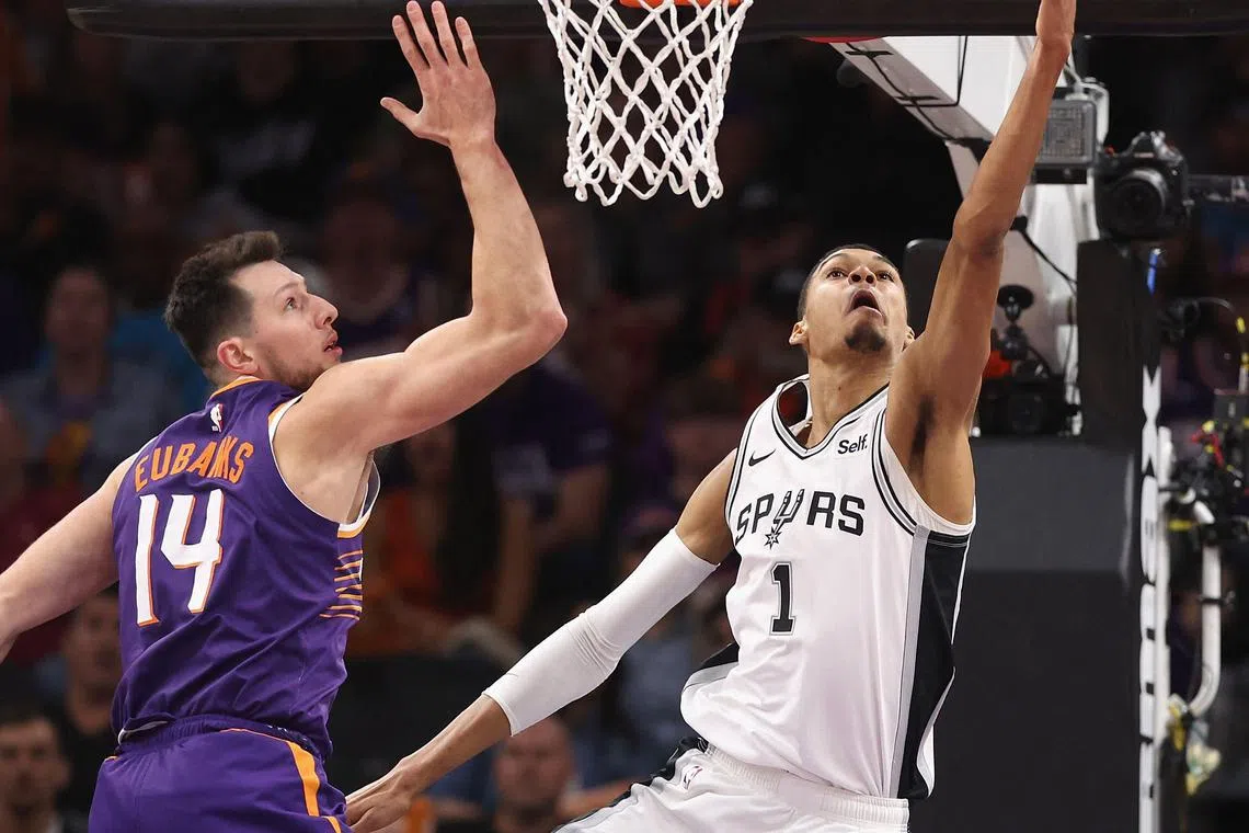 Victor Wembanyama of the San Antonio Spurs lays up a shot past Drew Eubanks of the Phoenix Suns during the second half of the NBA game at Footprint Centre on Thursday. Spurs won 132-121.