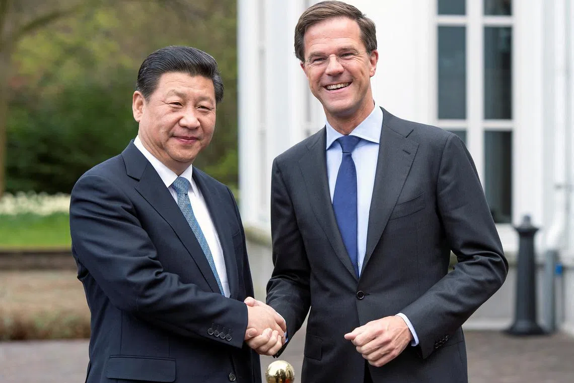 Prime Minister Mark Rutte (R) of the Netherlands welcomes China's President Xi Jinping on the second day of his state visit, at The Hague March 23, 2014. REUTERS/Paul Vreeker/United Photos/File Photo