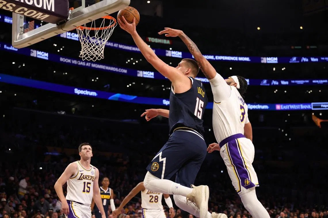 Denver Nuggets centre Nikola Jokic going to the basket past Los Angeles Lakers forward Anthony Davis during the second quarter at Crypto.com Arena. Jokic scored 34 points and grabbed 13 rebounds to spark the Nuggets to a 127-102 win on Nov 23.