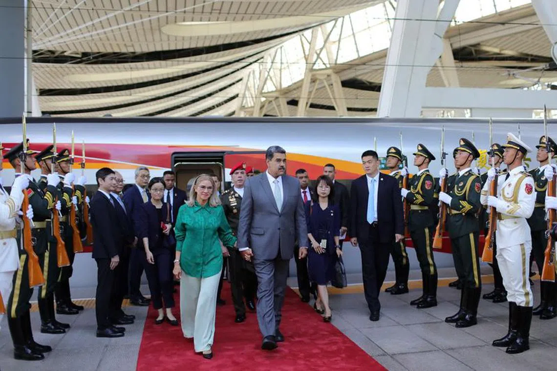 Venezuela's President Nicolas Maduro and his wife Cilia Flores walk together after arriving, in Beijing, China September 12, 2023. Miraflores Palace/Handout via REUTERS