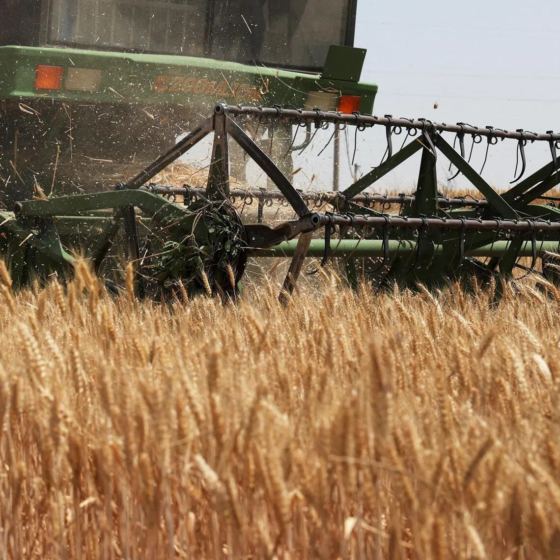 A combine harvester works on a wheat field at Qian county in Xianyang, Shaanxi province, China.