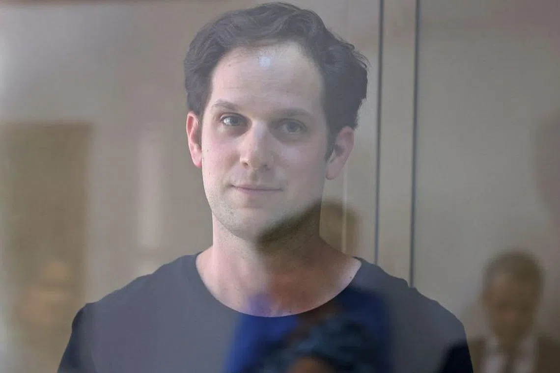 Wall Street Journal reporter Evan Gershkovich, who was arrested in March while on a reporting trip and accused of espionage, stands behind a glass wall of an enclosure for defendants before a court hearing to consider an appeal against his detention, in Moscow, Russia June 22, 2023. REUTERS/Evgenia Novozhenina/File Photo