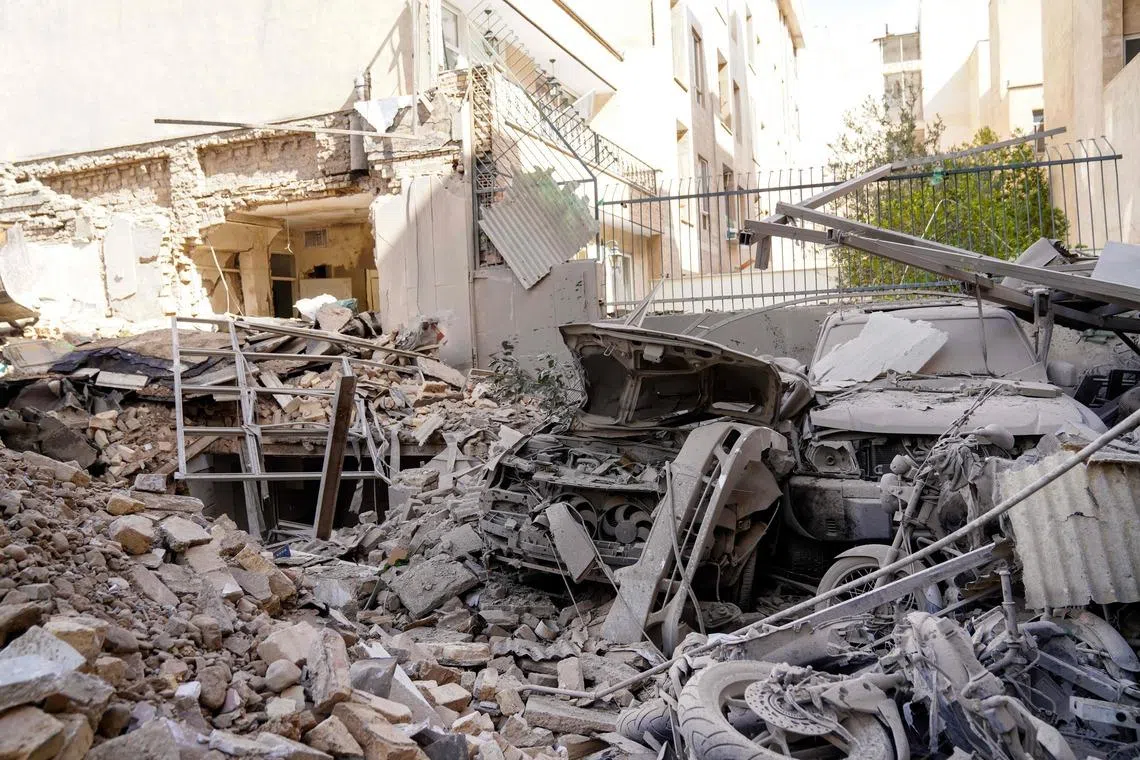 Rubble and debris covering destroyed vehicle following a missile strike on a neighborhood of the Iranian capital Tehran,  on Feb 28, 2026. 