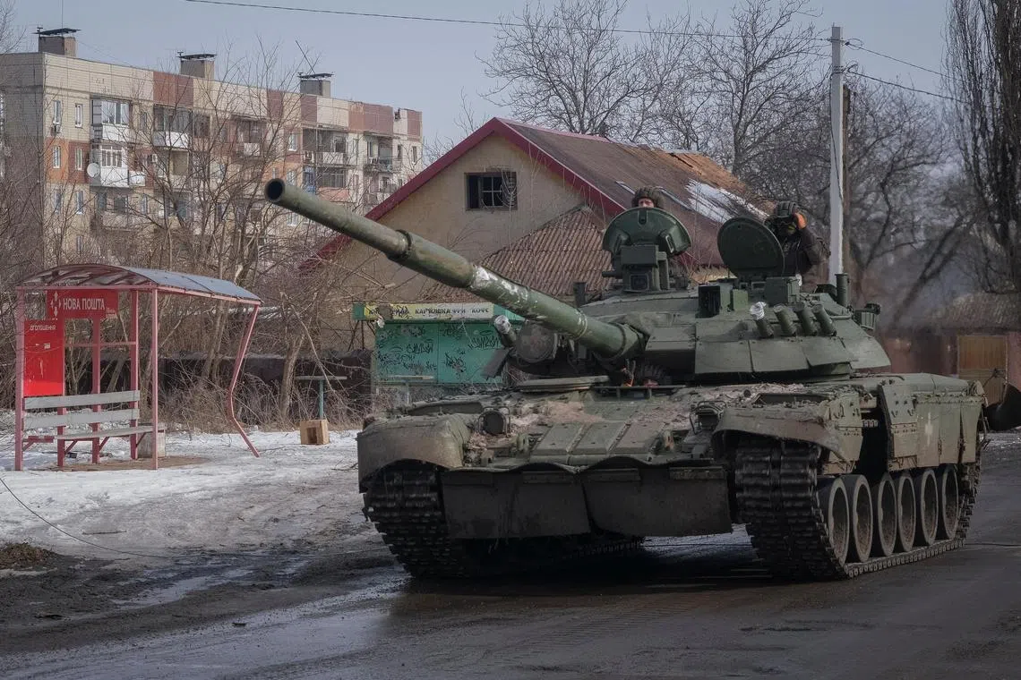 Ukrainian servicemen ride a tank in the front-line city of Bakhmut, Ukraine, on Feb 24, 2023.