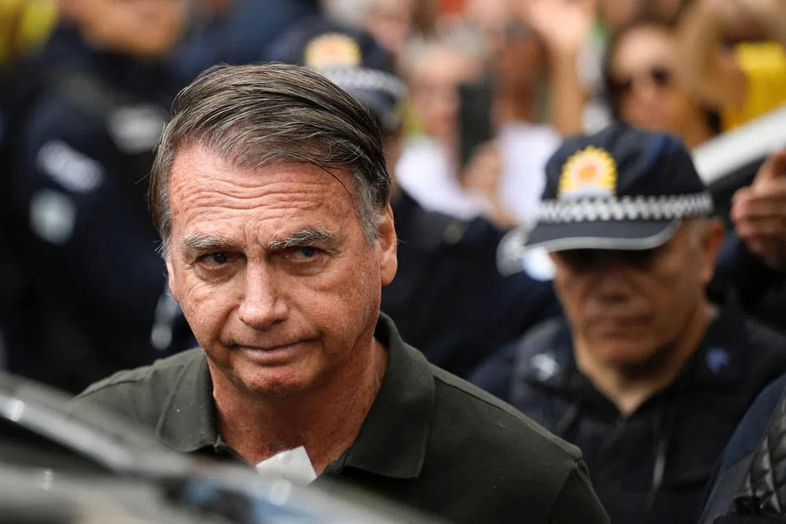Former Brazilian President Jair Bolsonaro leaves the hospital where he went to undergo a skin surgery procedure, authorized by Supreme Court Justice Alexandre de Moraes, leaving the house arrest after being convicted by a Supreme Court majority of plotting a coup to remain in power after losing the 2022 election, in Brasilia, Brazil, September 14, 2025. REUTERS/Mateus Bonomi/File Photo