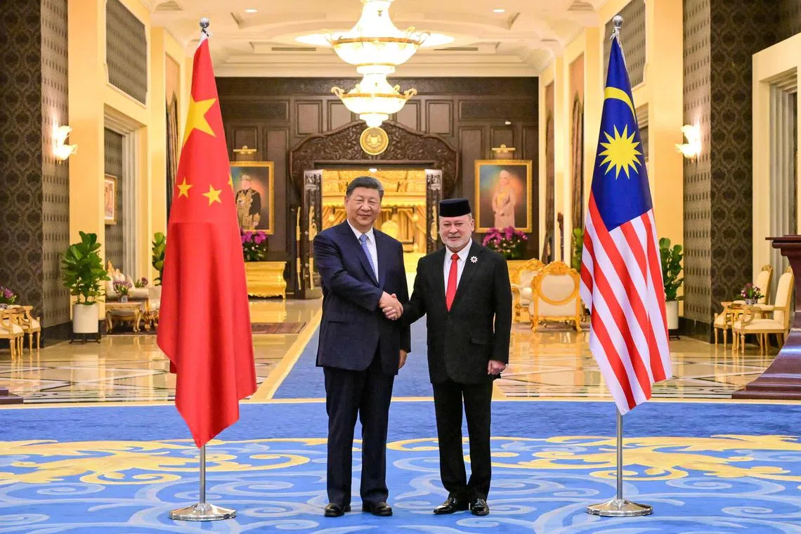 CORRECTION / This handout photo taken and released by Malaysia's Department of Information on April 16, 2025 shows Malaysia's King Sultan Ibrahim (R) shaking hands with China's President Xi Jinping (L) after the welcoming ceremony at the National Palace in Kuala Lumpur. (Photo by AZALI ARIFFIN / MALAYSIA'S DEPARTMENT OF INFORMATION / AFP) / RESTRICTED TO EDITORIAL USE - MANDATORY CREDIT "AFP PHOTO / MALAYSIA'S DEPARTMENT OF INFORMATION" - NO MARKETING NO ADVERTISING CAMPAIGNS - DISTRIBUTED AS A SERVICE TO CLIENTS / “The erroneous mention[s] appearing in the metadata of this photo by AZALI ARIFFIN has been modified in AFP systems in the following manner: [April 16, 2025] instead of [April 15, 2025]. Please immediately remove the erroneous mention[s] from all your online services and delete it (them) from your servers. If you have been authorized by AFP to distribute it (them) to third parties, please ensure that the same actions are carried out by them. Failure to promptly comply with these instructions will entail liability on your part for any continued or post notification usage. Therefore we thank you very much for all your attention and prompt action. We are sorry for the inconvenience this notification may cause and remain at your disposal for any further information you may require.”