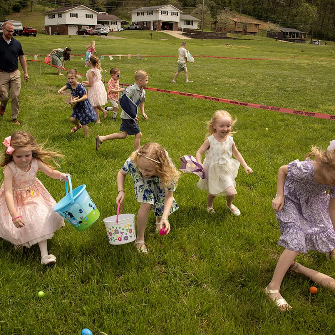 Children, including Everly Dickens, 4, Mea Milam, 8, and Demi Jones, 4, participate in an Easter egg hunt following the service at Amazing Grace Fellowship church in Seth, West Virginia, U.S., April 20, 2025. REUTERS/Adrees Latif