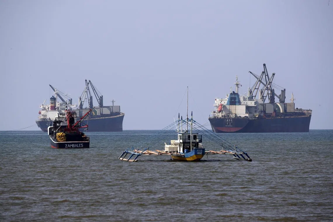 Chinese vessels anchored next to Filipino-owned fishing boats in Santa Cruz, in the Philippines' Zambales province, on Dec 13.