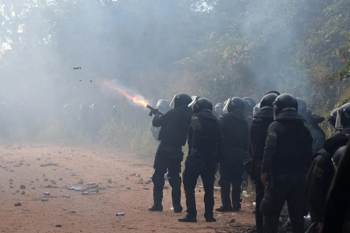 Police officers fire tear gas while clashing with community members who seized the Humberto Suarez oil facility to call for the resignation of President Rodrigo Paz, as ongoing protests have led to shortages of fuel and food, in Santa Rosa del Sara, Bolivia, June 3, 2026. REUTERS/Ipa Ibanez