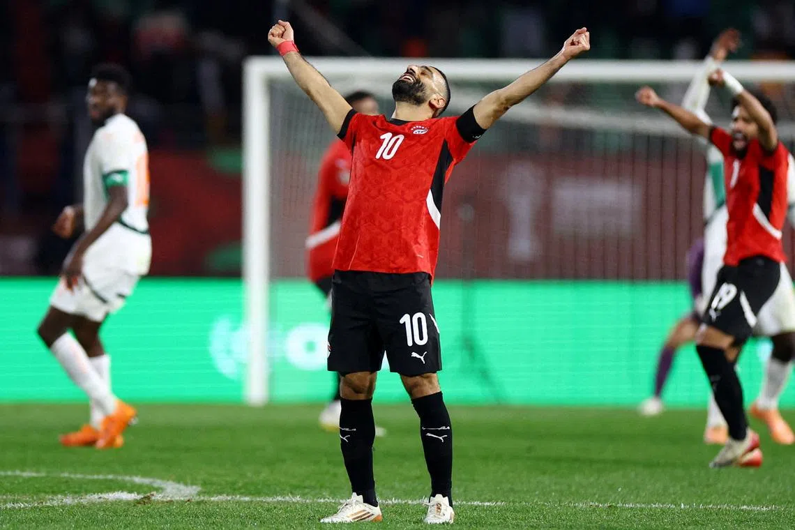 Mohamed Salah raises his arms in celebration after Egypt edged out holder Ivory Coast to reach the Afcon semi-finals.