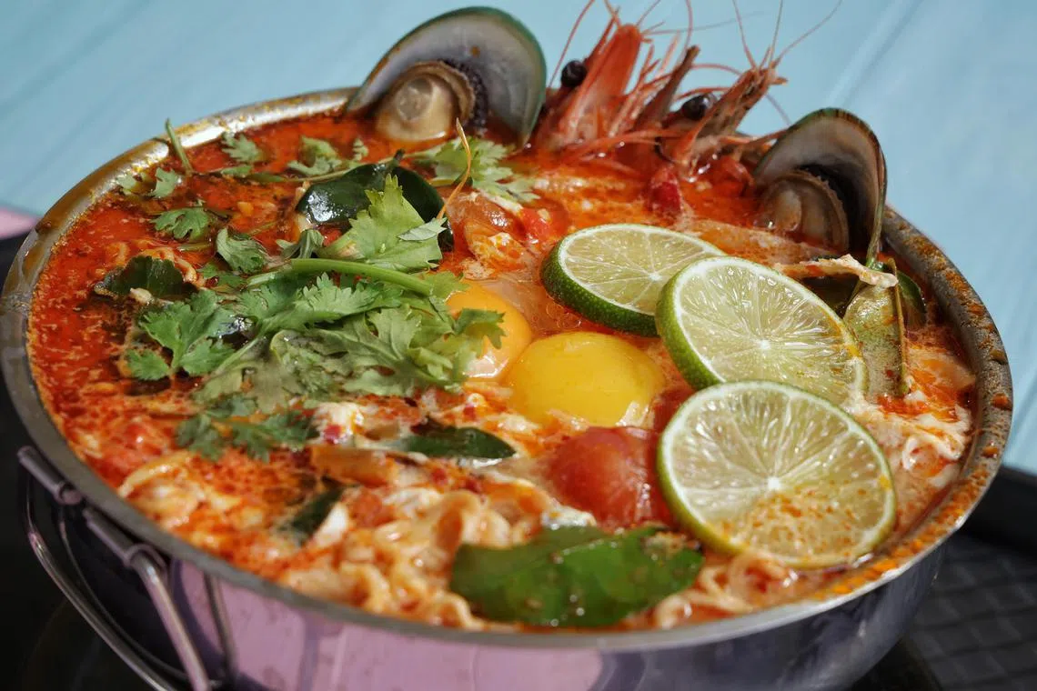 Tom Yum seafood noodles from Streets of Bangkok at Cosford Container Park on Jan 29, 2024. Feature on new foodie enclaves - The 35,000 sq ft Cosford Container Park opens on Jan 29 with plenty of food options and community spaces with views of Changi Airport's landing strip.