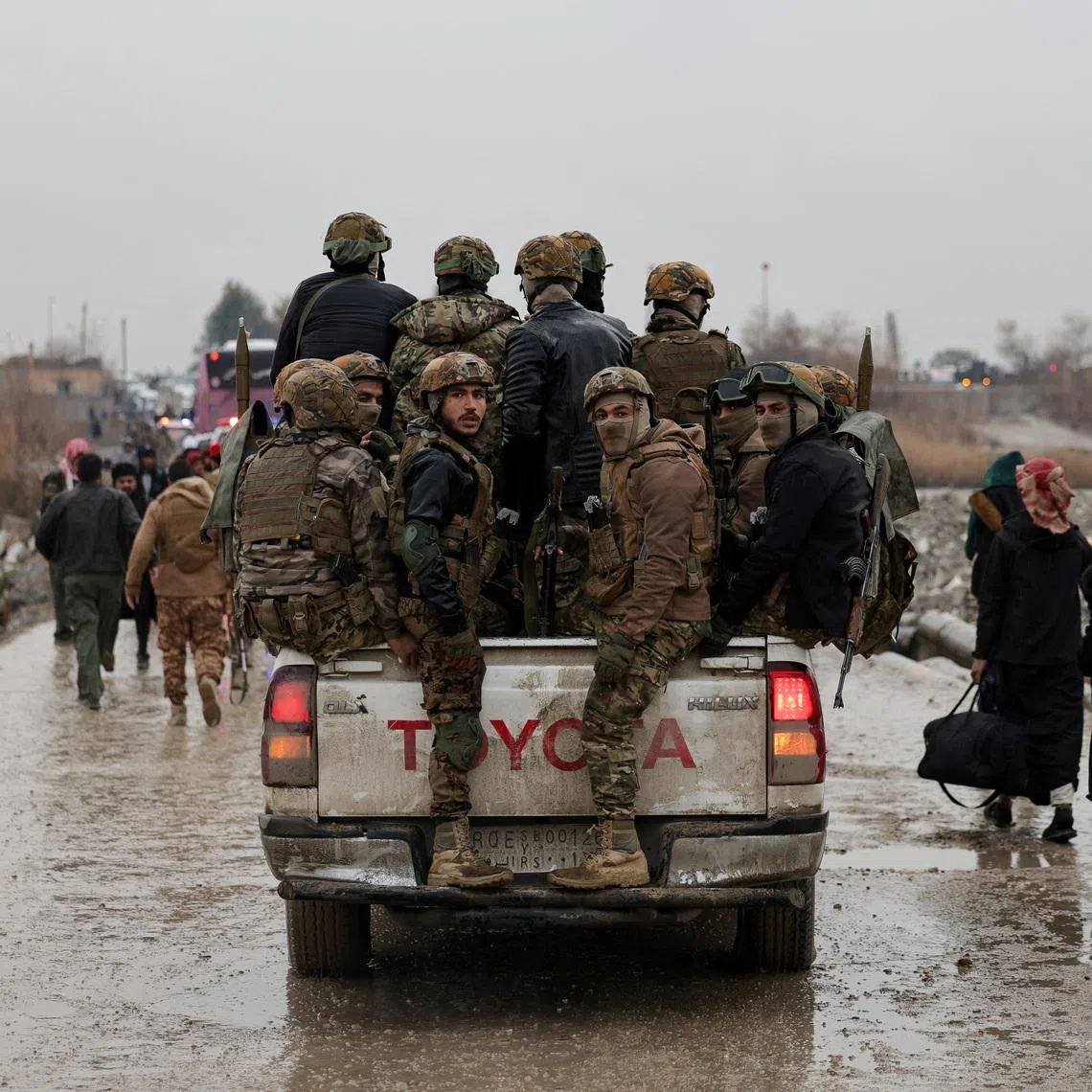 FILE PHOTO: Military personnel in a vehicle at the crossing connecting the two banks of the Euphrates River, as they attempt to cross to the other side after the Syrian Democratic Forces (SDF) withdrew from Deir al-Zor province and the Syrian army took full control over the area, in Deir al-Zor, Syria, January 18, 2026. REUTERS/Khalil Ashawi/File Photo