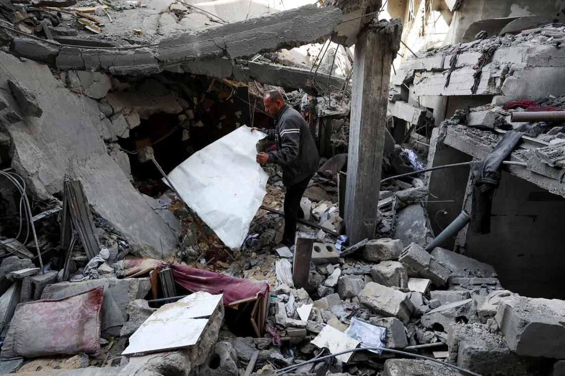 A Palestinian man inspects the damage at the site of an Israeli strike on a house, in the northern Gaza Strip, April 18, 2025. REUTERS/Mahmoud Issa