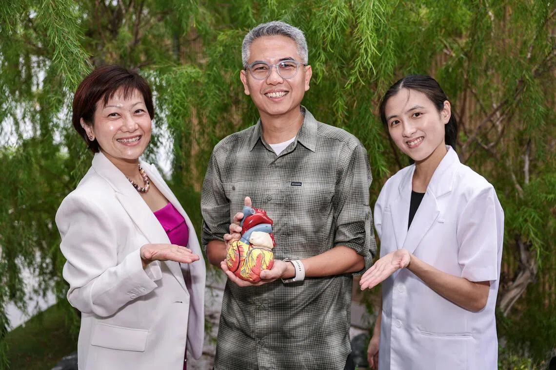 IT professional Gan Chee Hiong (centre) with cardiology specialist pharmacist Doreen Tan (left) and principal clinical pharmacist Elaine Lo.