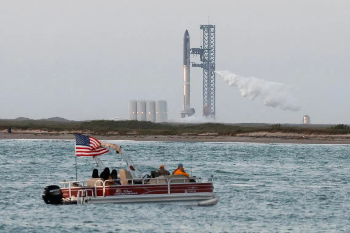 Spectators watch from a boat before SpaceX's Starship lifts off from the launchpad on an orbital test mission on April 17, 2023.